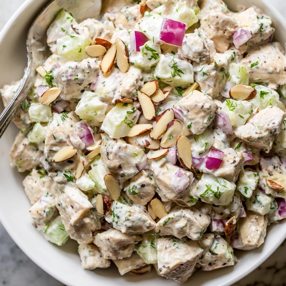Chilled Healthy Greek Yogurt Chicken Salad Recipe served on greens with lemon