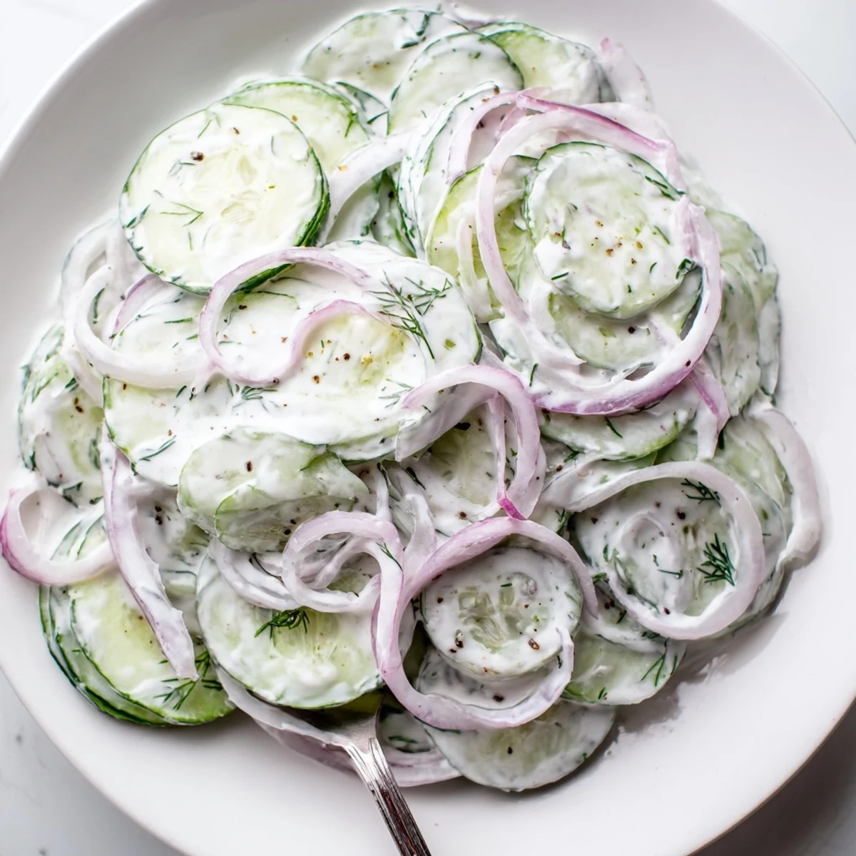 Chilled cucumbers and red onion swathed in garlicky yogurt dressing — Tzatziki Cucumber Salad Recipe