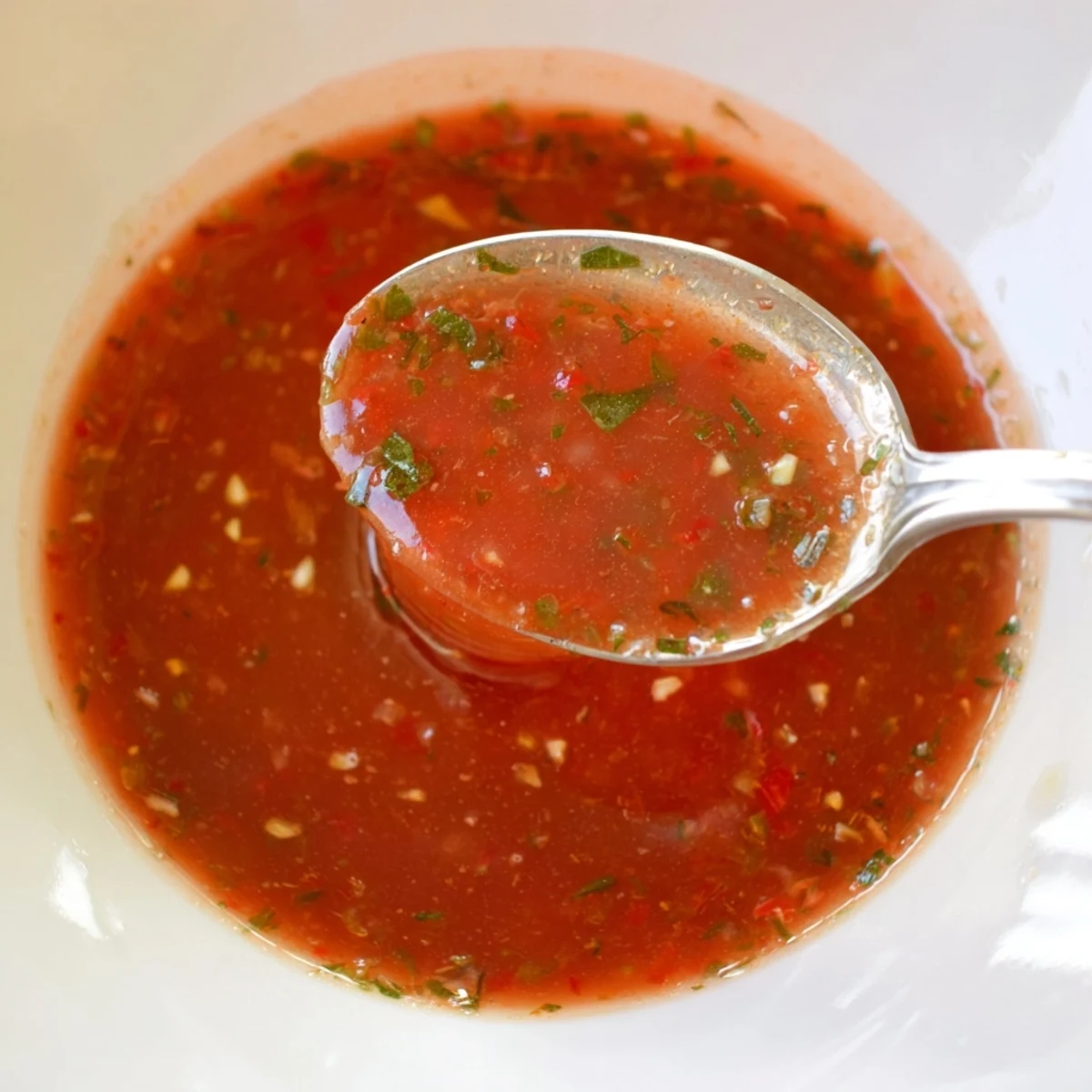 Tomato Basil Vinaigrette gleaming in jar, tangy, herbaceous, ready to drizzle