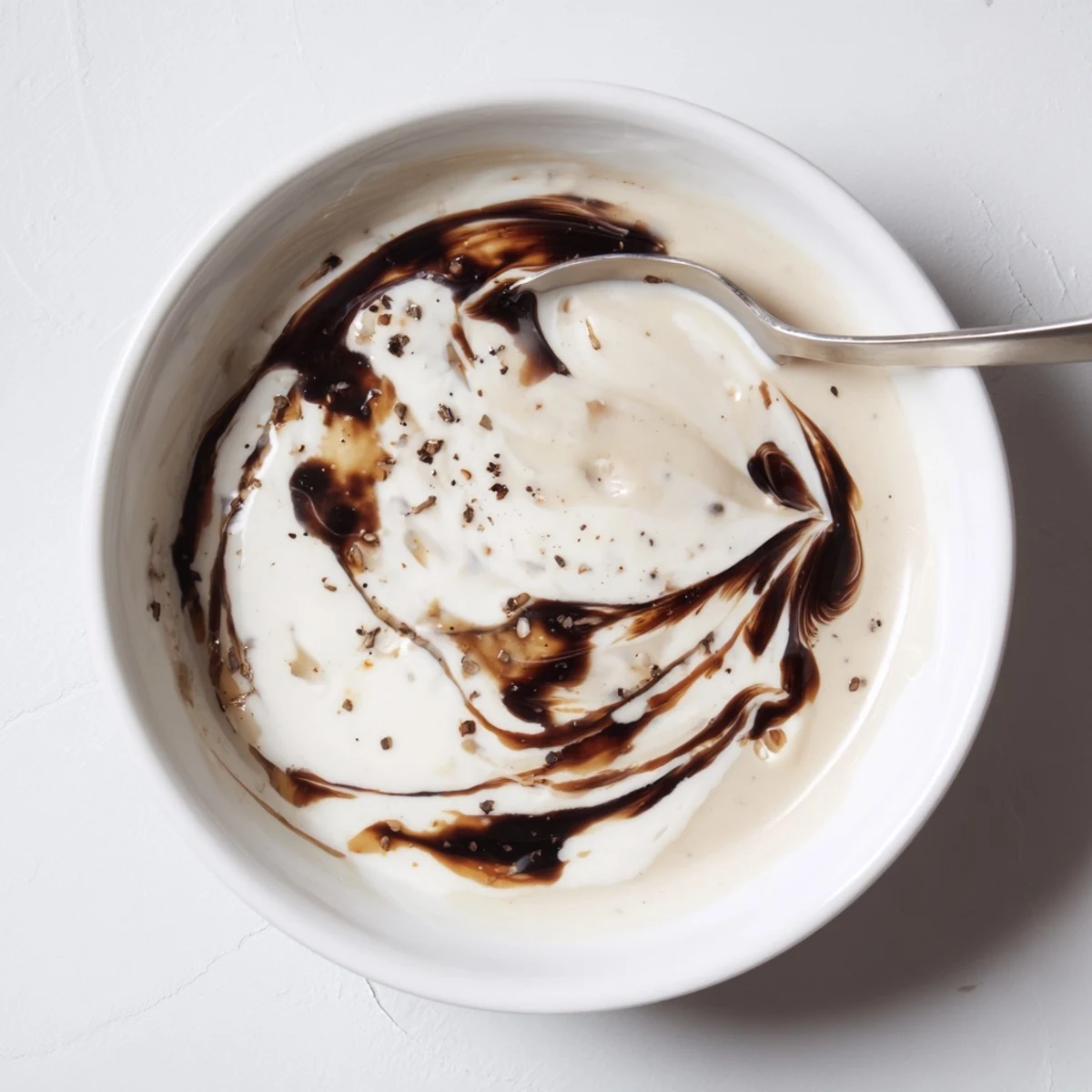 Jar of Creamy Balsamic Vinaigrette whisked silky, garlicky aroma, ready to serve