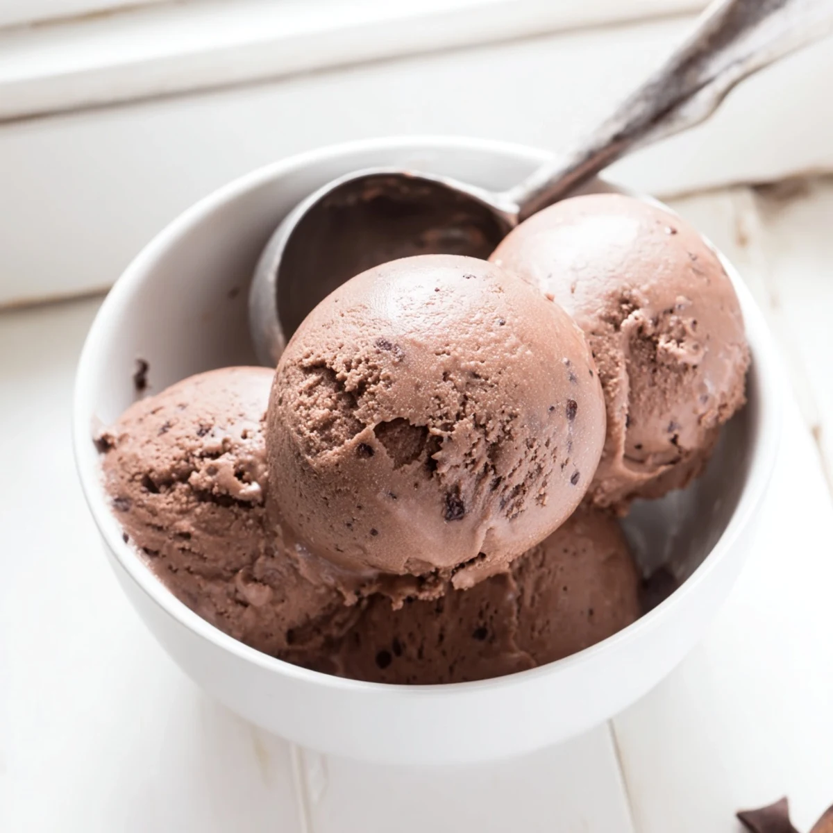 Dark chocolate sourdough ice cream topped with fresh raspberries and a sprinkle of sea salt