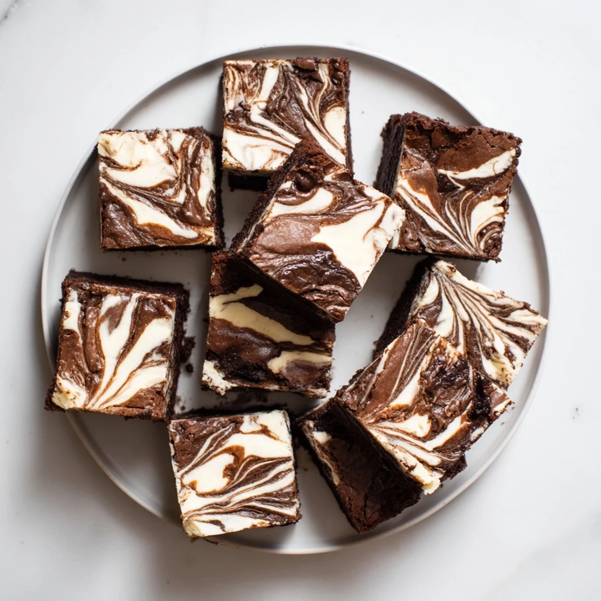 Sliced sourdough cheesecake brownie bars showing the swirled chocolate and vanilla cream cheese layers