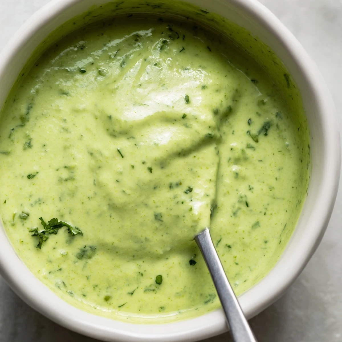 Vibrant Peruvian green sauce aji verde served as dipping sauce with crispy golden fries