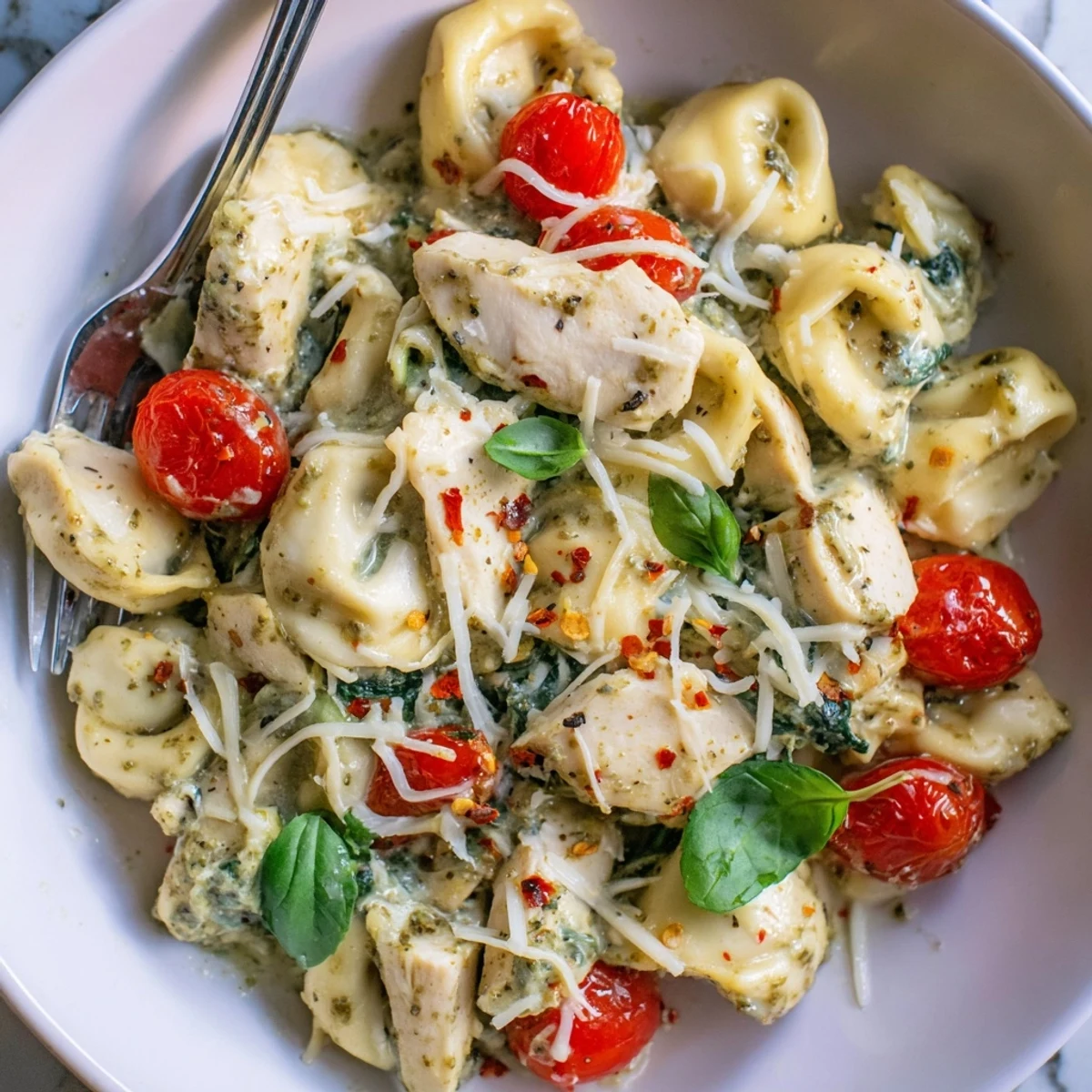 Slow Cooker Tortellini Casserole With Cheesy Chicken Pesto, oozy melted cheese and basil.