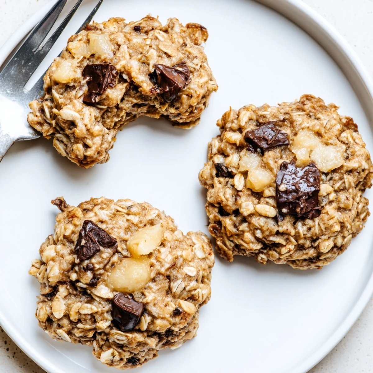 Fresh-baked Banana Oat Cookies with melty chocolate chips, hearty oat aroma
