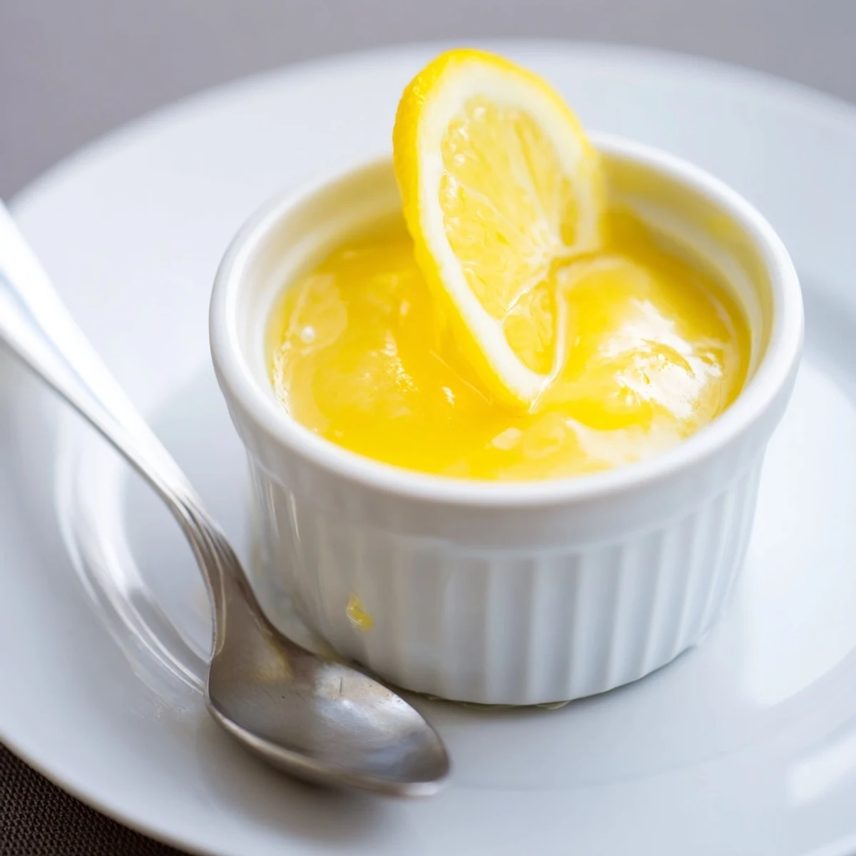 Jar of Homemade Lemon Curd thickly spread on warm buttered toast