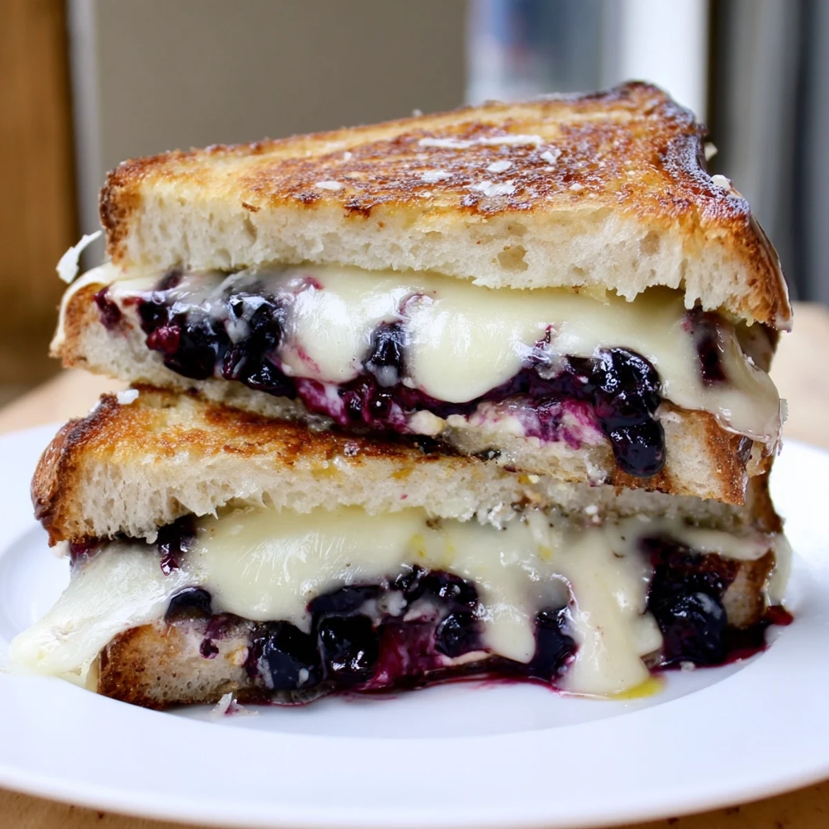 Crispy Blueberry Grilled Cheese with golden crust, gooey cheddar, fresh blueberry jam