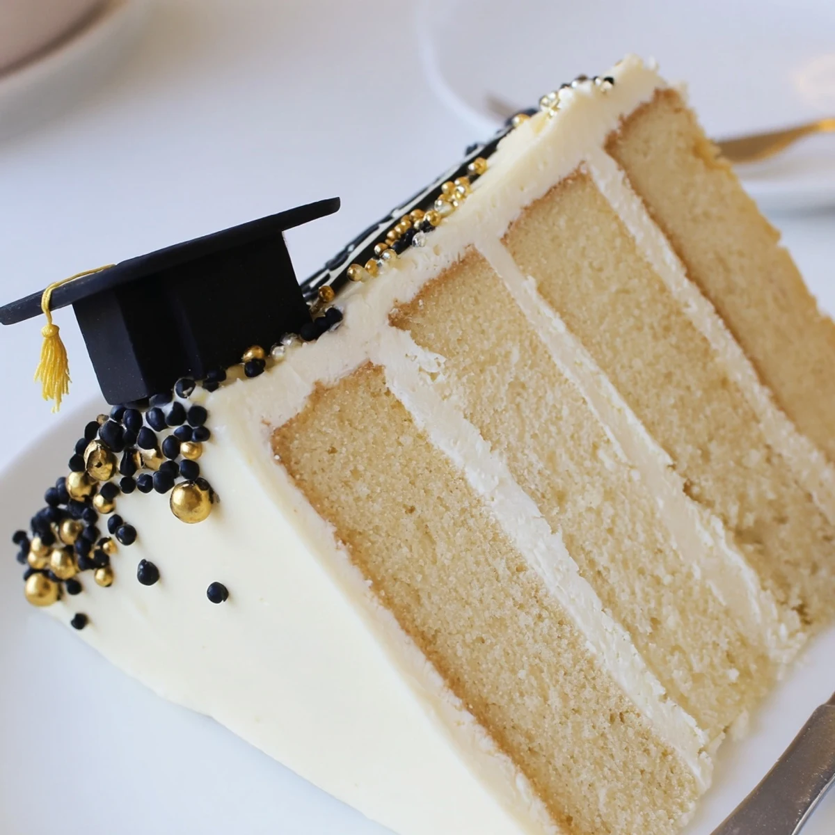 Freshly frosted Graduation Cake Recipe decorated with fondant caps, perfect for celebrations.