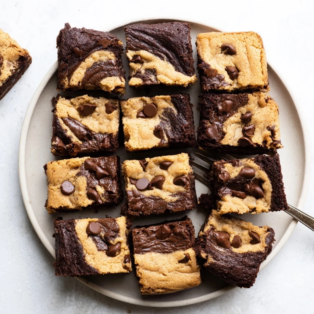Square pan of homemade fudgy chewy brookies sliced into squares showing dual texture layers