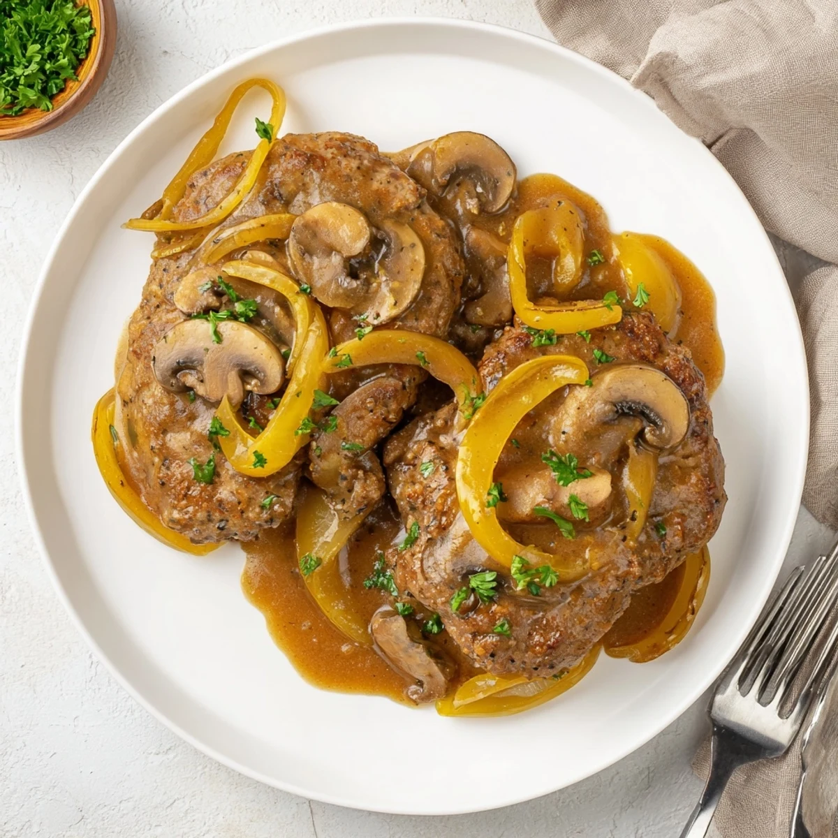 Tender beef cube steaks simmered in creamy Southern brown gravy with sliced onions and mushrooms