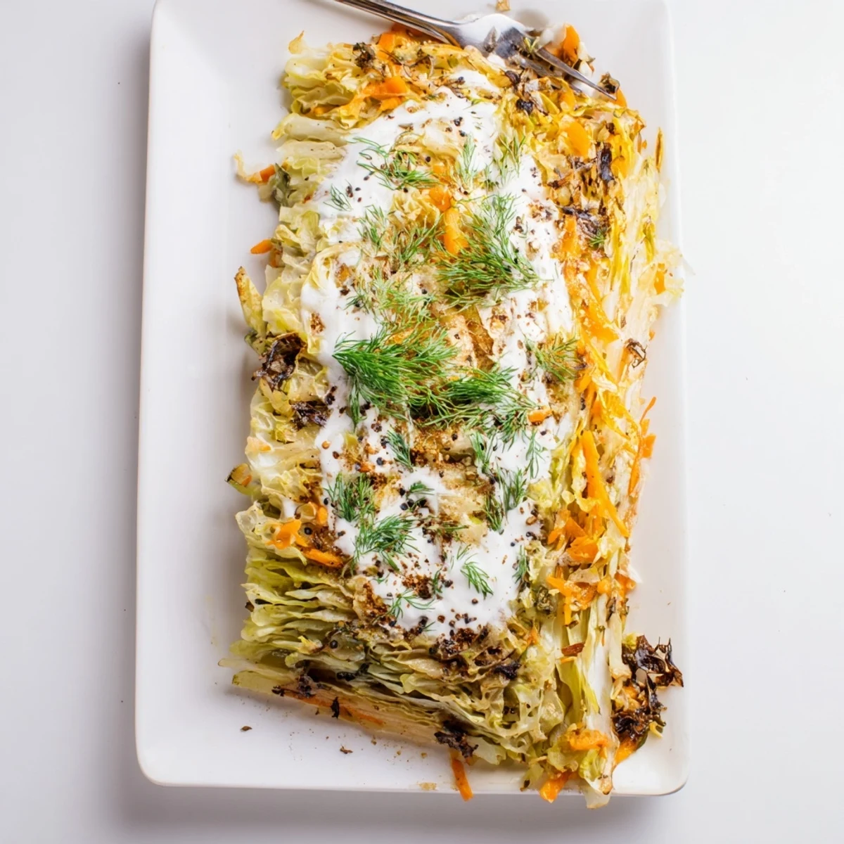 Hearty German style casserole with layered tender cabbage and tangy sauerkraut baked until bubbling