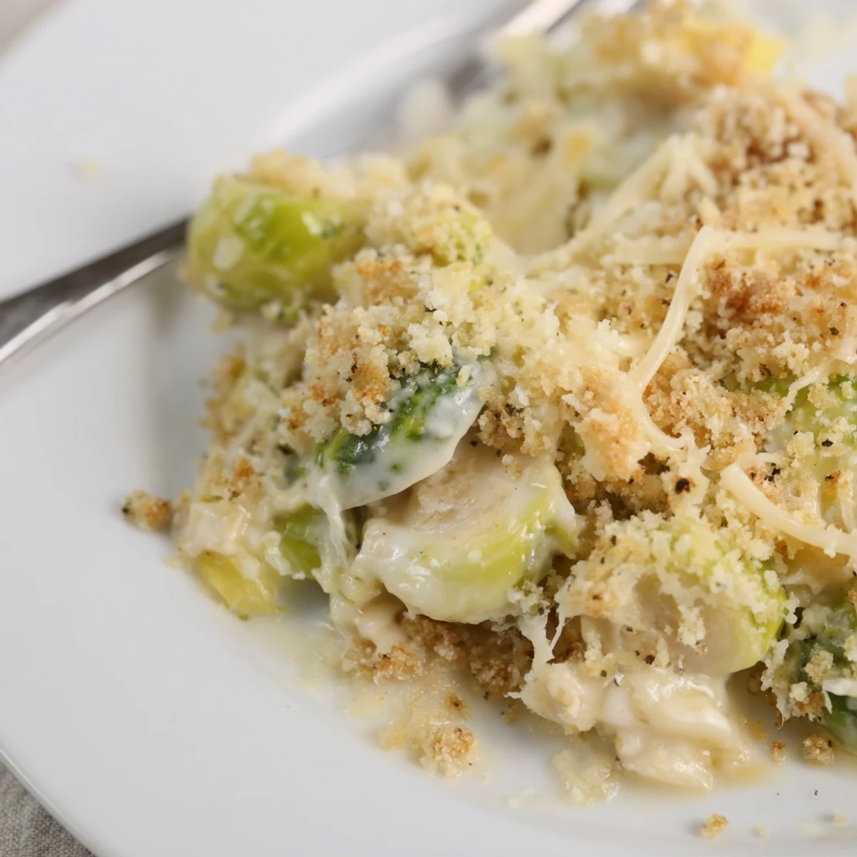 A steaming Creamy Parmesan Brussels Sprouts Casserole, fragrant with garlic and thyme