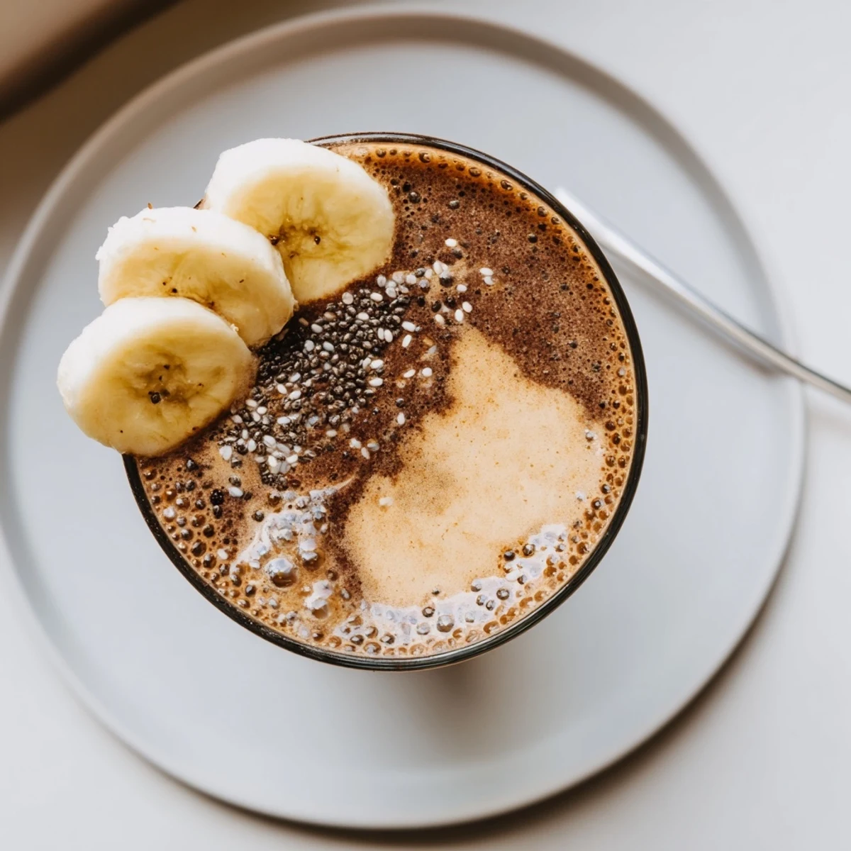 Thick Raw Chocolate Banana Shake dusted with cacao, ideal morning energizing drink