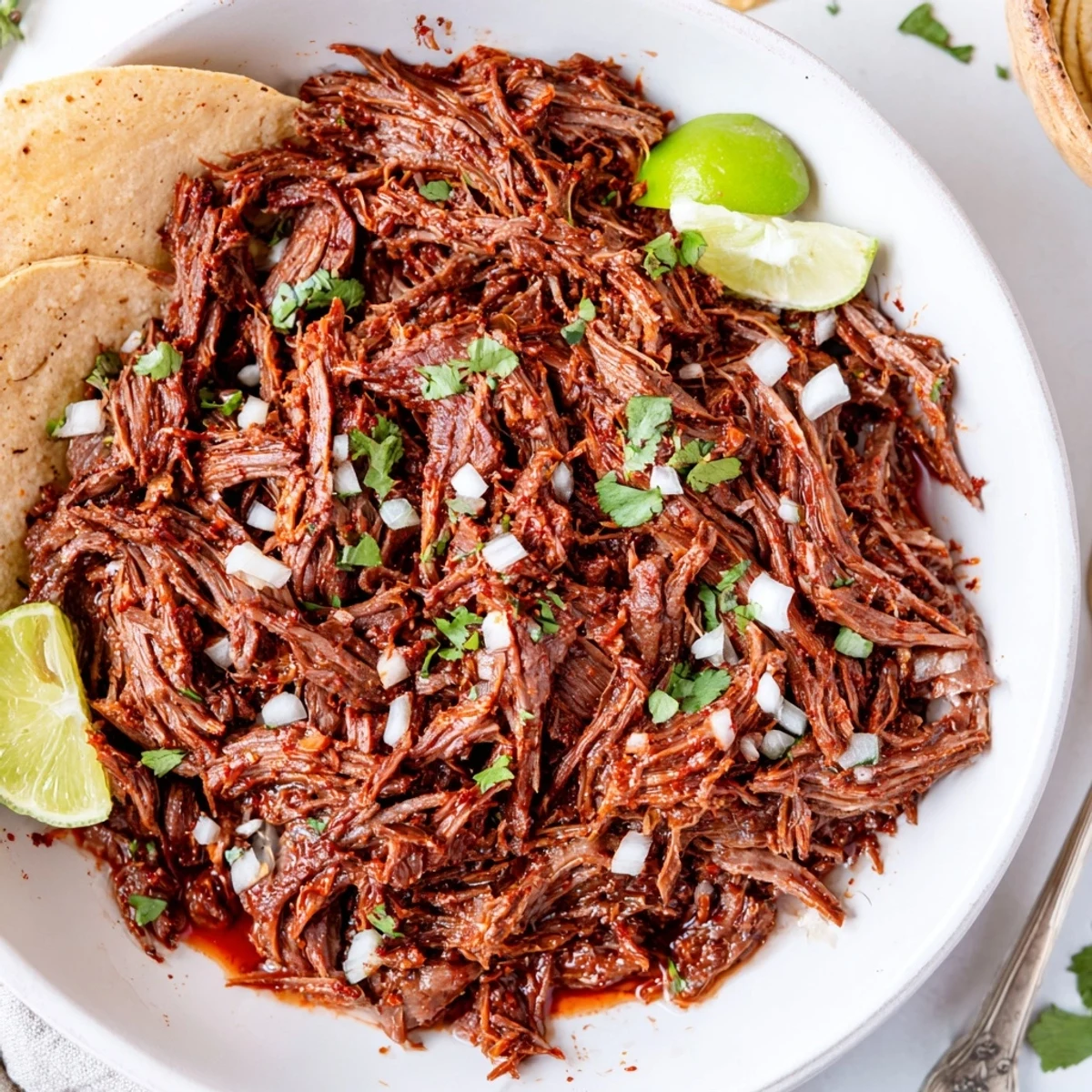 Shredded Slow Cooker Beef Barbacoa bubbling in savory juices, ready for tacos