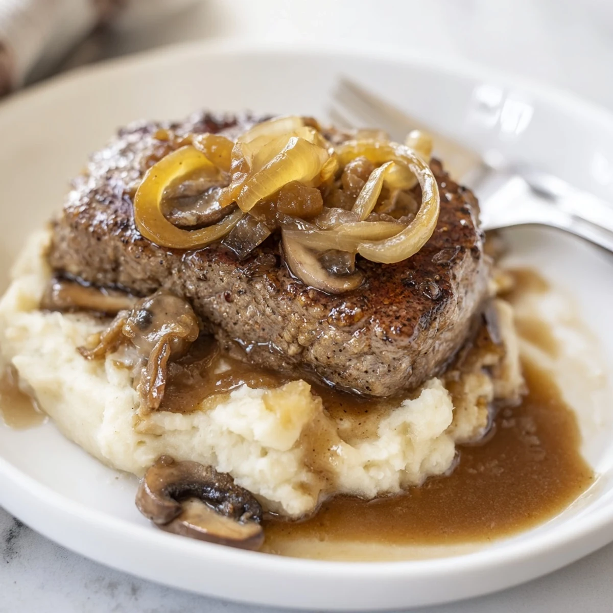 Warm Country Style Smothered Cube Steak Recipe tender steaks nestled in creamy gravy