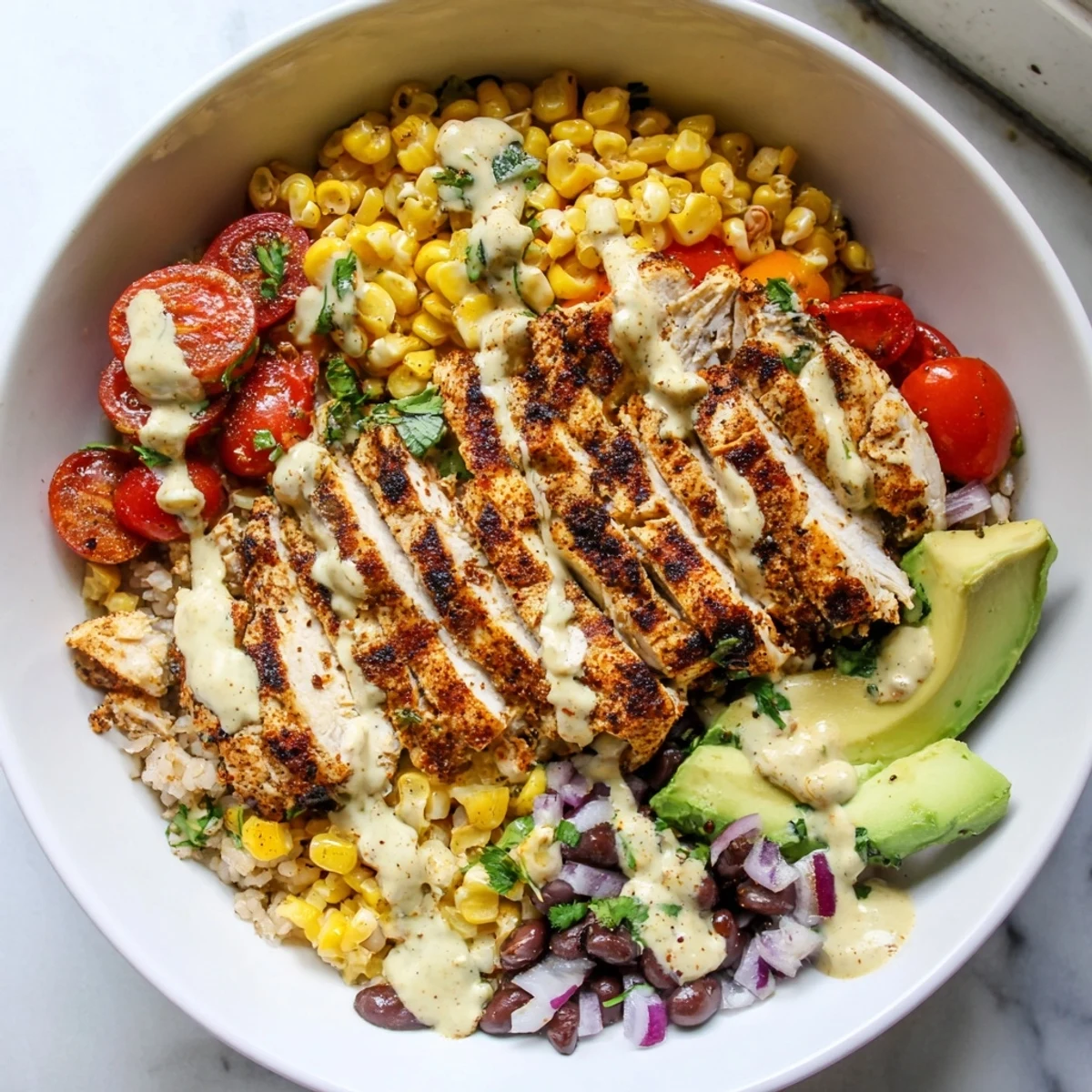Grilled chicken slices over brown rice in this Healthy Street Corn Chicken Bowl