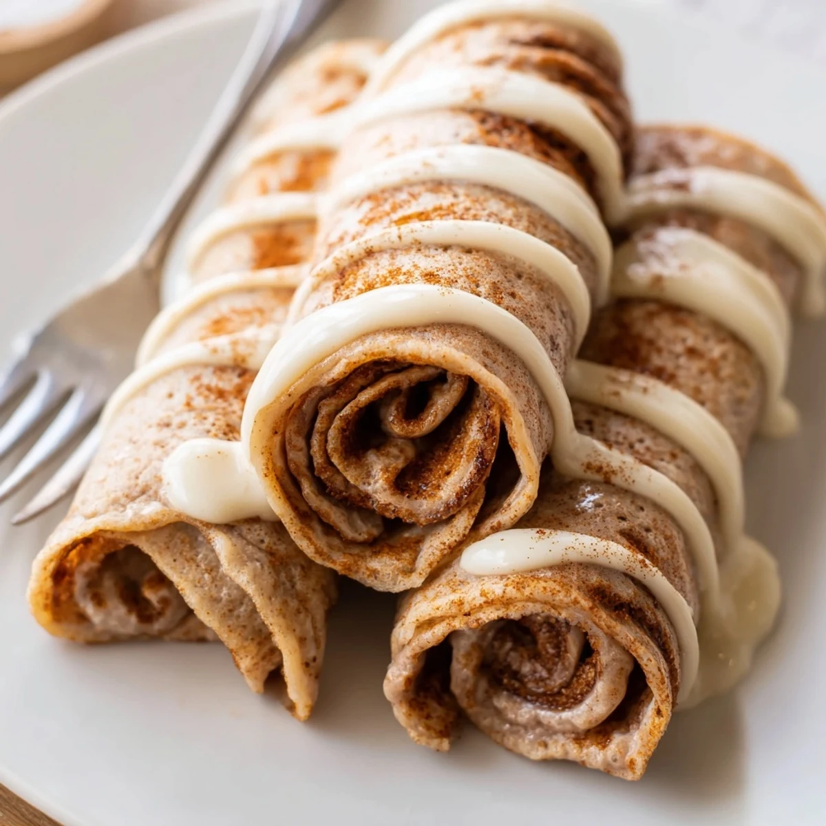 Warm cinnamon roll protein crepes rolled tightly with a spiced brown sugar filling.