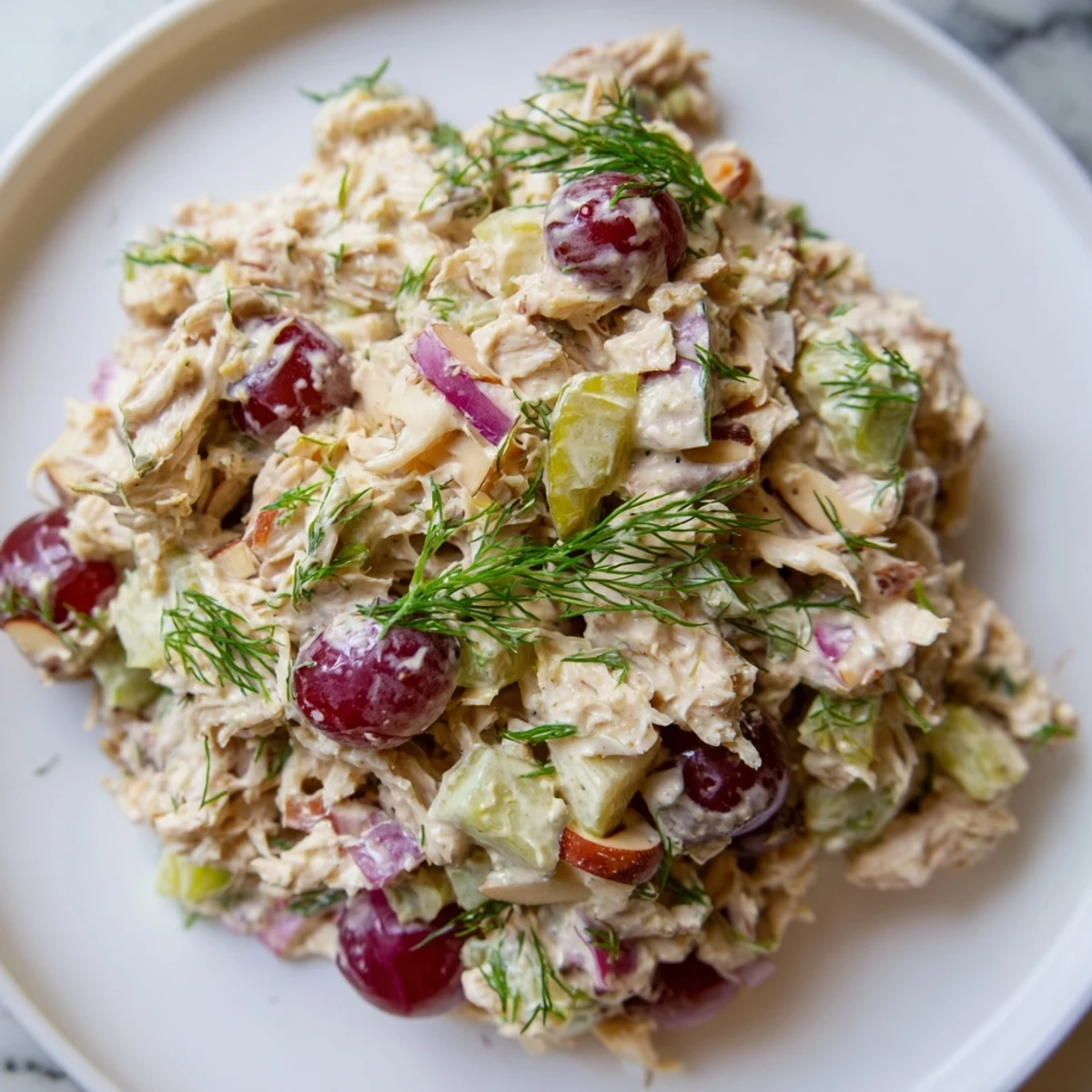 A vibrant bowl of vegan chicken salad tossed with crunchy celery and dill