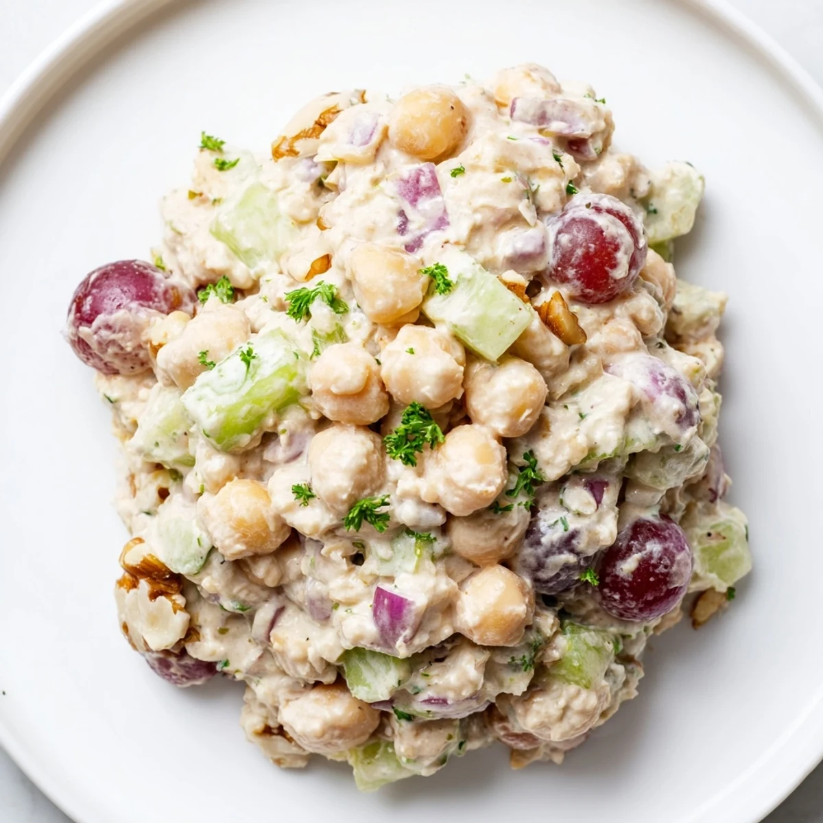 Hearty vegan chicken salad in a wrap featuring mashed chickpeas and tangy dairy-free dressing