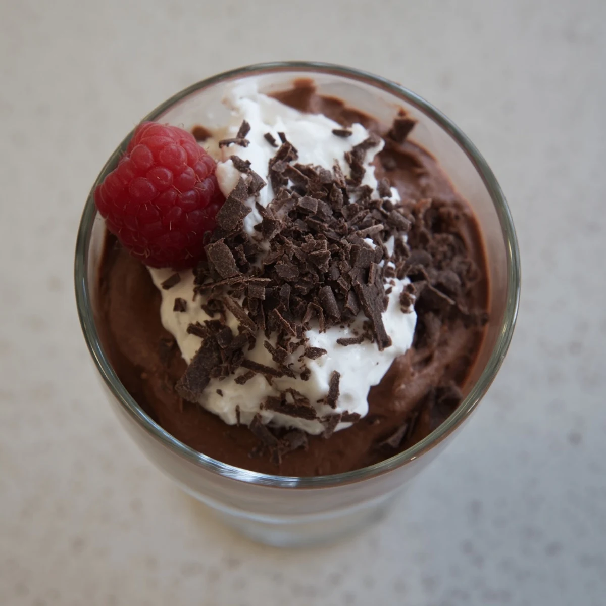 Creamy chocolate mousse spooned into ramekins with a smooth velvety texture
