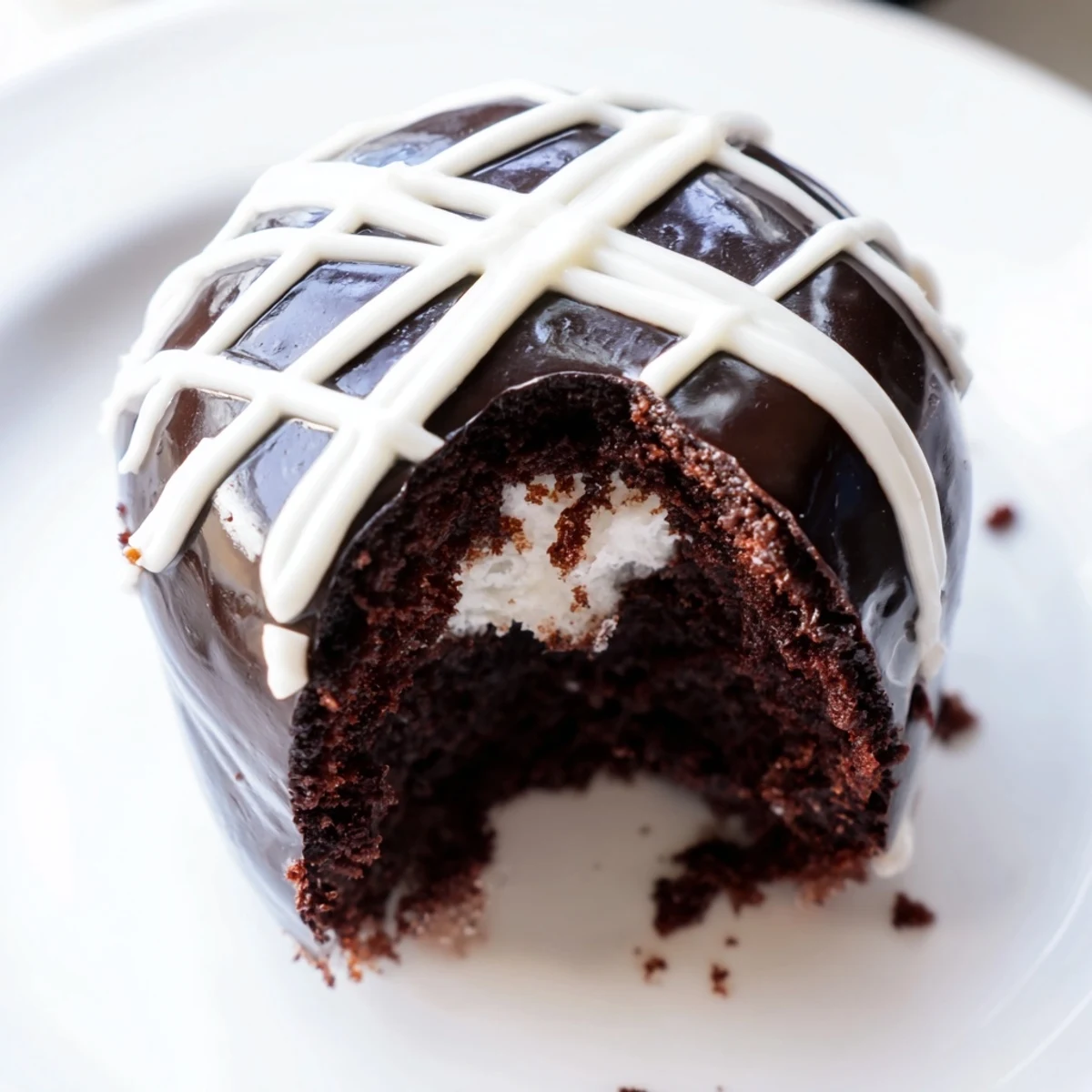 Homemade Hostess Cupcakes with glossy chocolate ganache and pillowy marshmallow filling