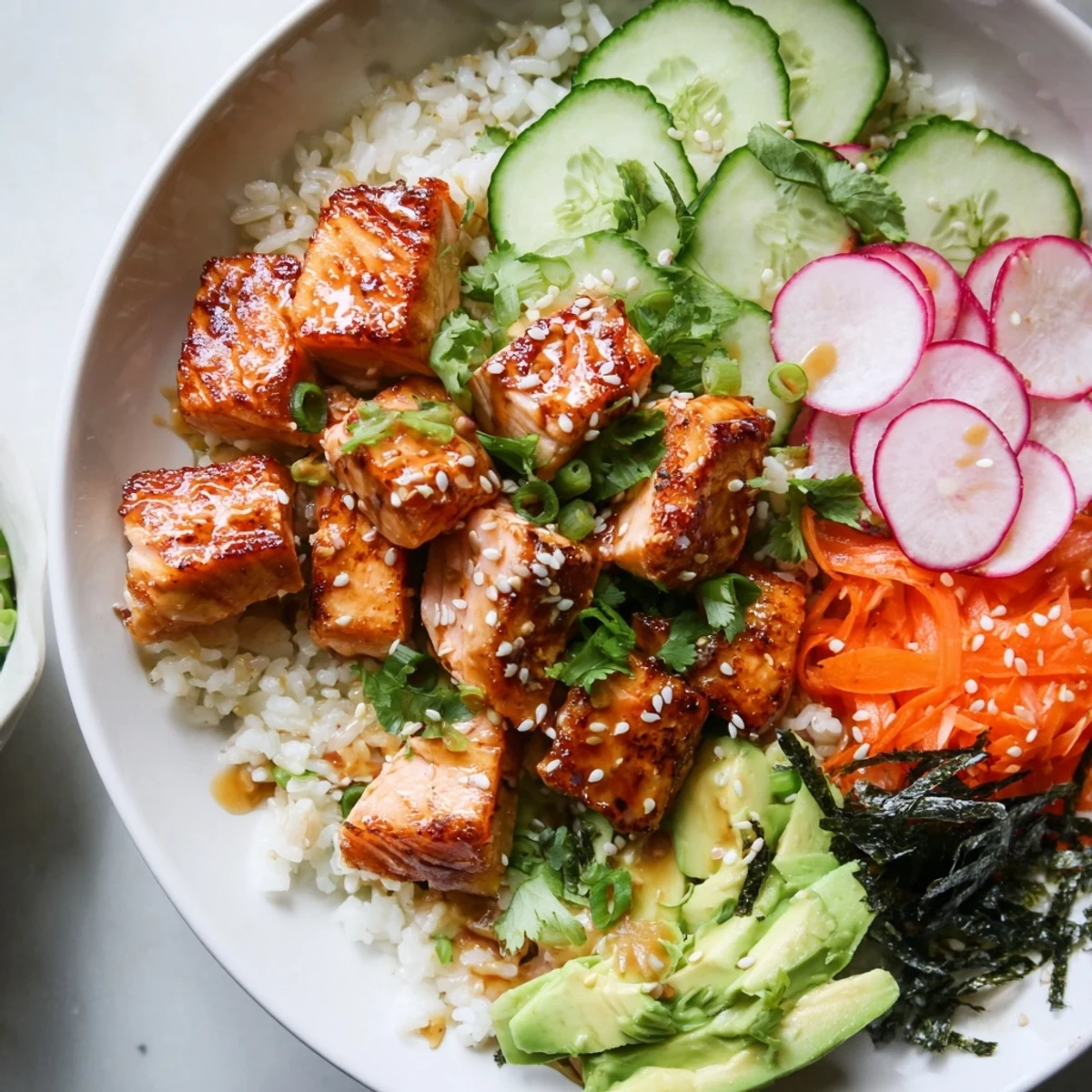 Crispy salmon rice salad with ginger dressing served over fluffy jasmine rice and fresh avocado