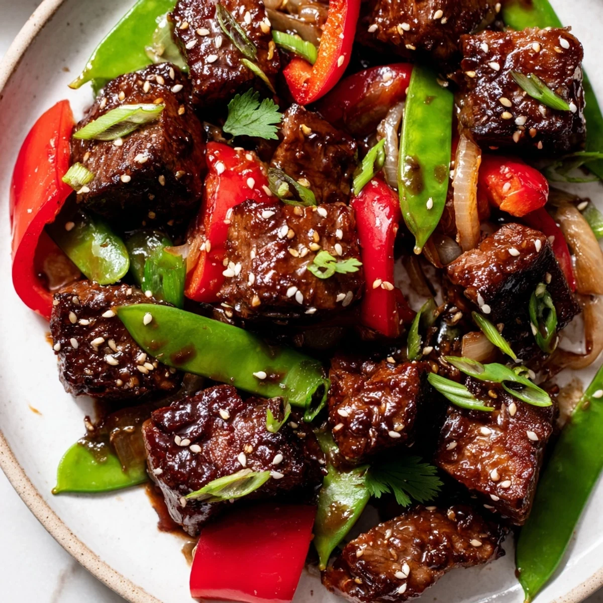 Tender Asian-inspired cube steak glistening with soy-ginger glaze and crisp stir-fried vegetables