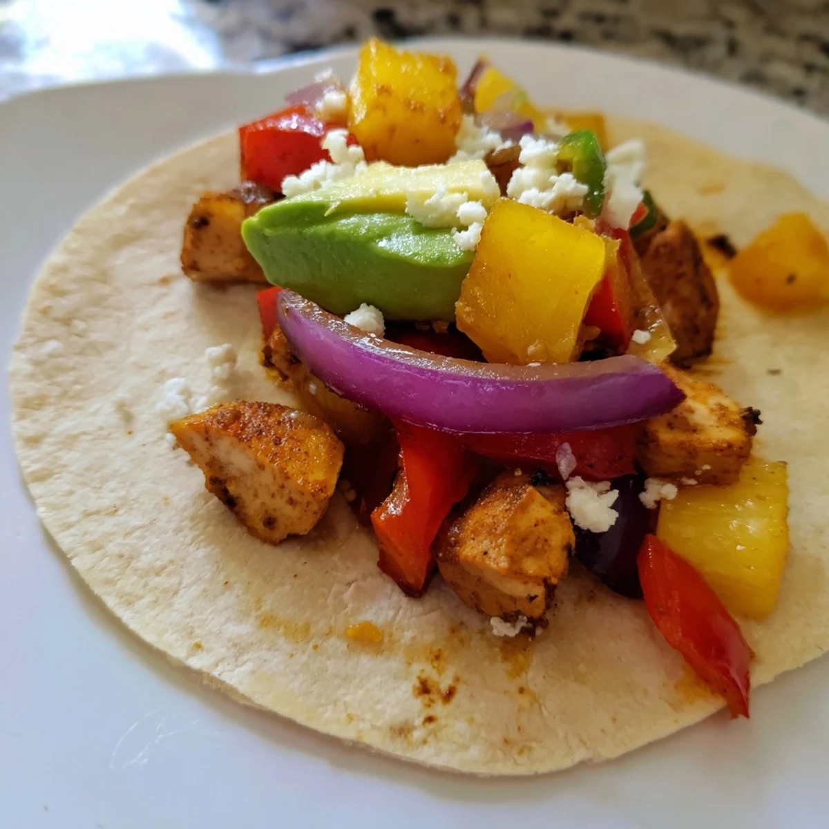 Sizzling chicken and caramelized pineapple fill warm tortillas for an easy taco night.  