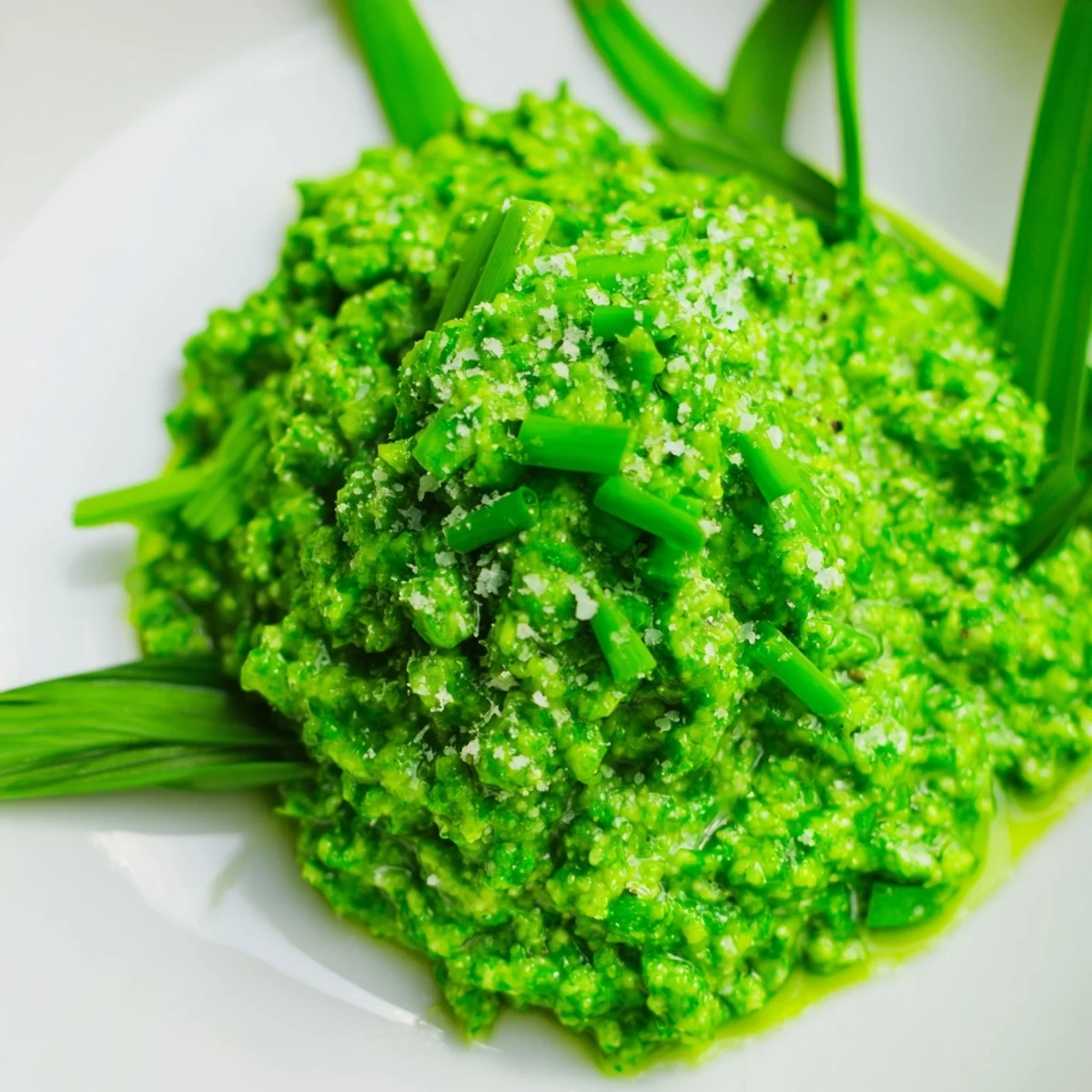 Creamy garlic scape pesto spread on toasted artisan bread with lemon zest  