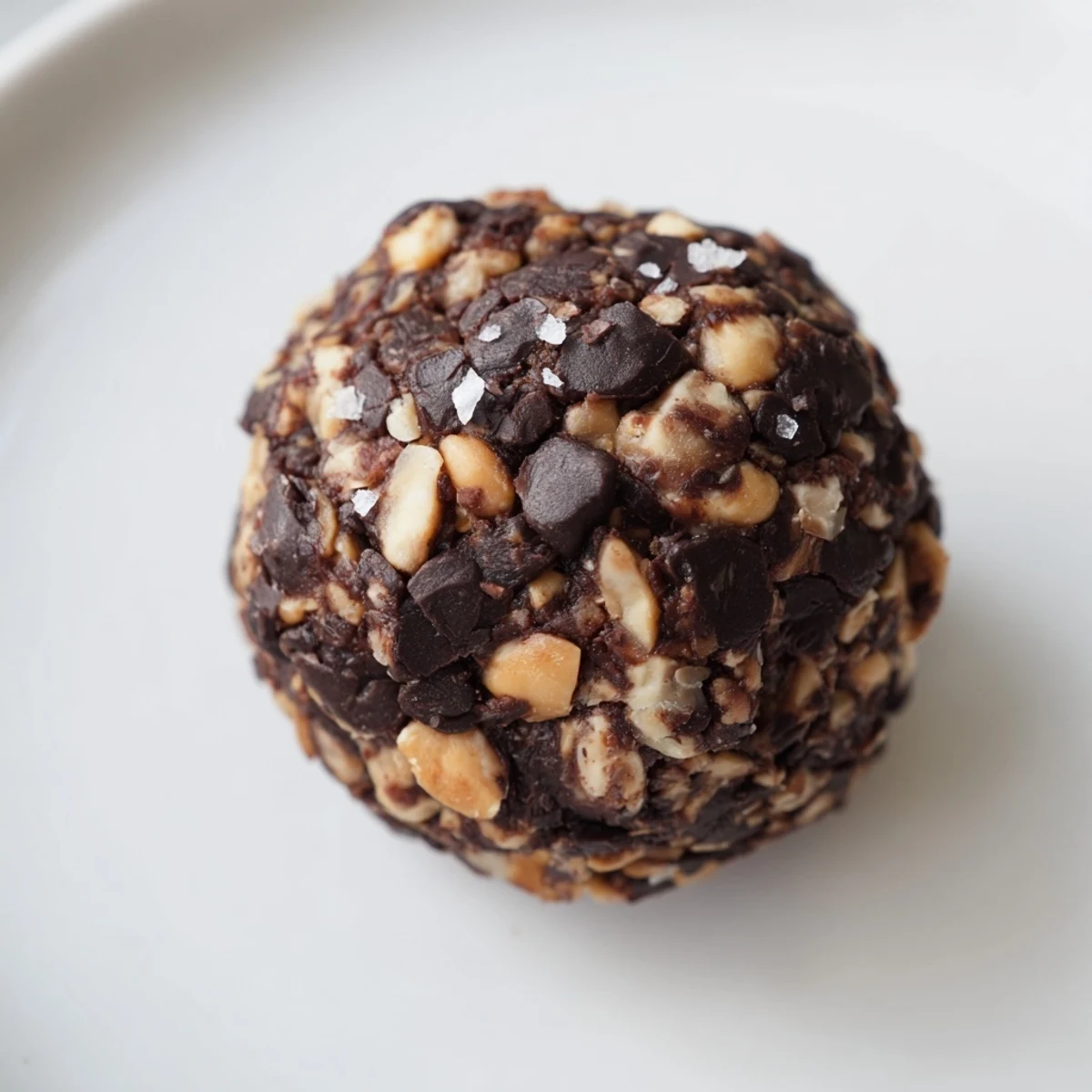 Rich chocolate Snickers energy bites topped with sea salt and chopped peanuts.