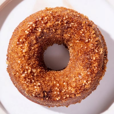 A close-up of freshly baked Spiced Apple Cider Donuts, perfect for a cozy fall treat.