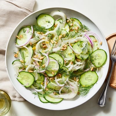 Refreshing bowl of crisp fennel cucumber salad drizzled with lemon and olive oil  